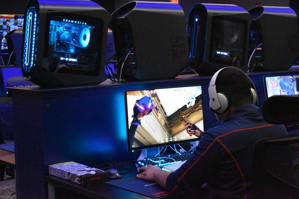A student sits at a computer screen playing a game as part of Utica University's eSports program.